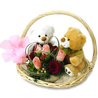 2 Teddies with flowers in a basket
