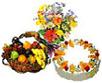 Hamper of Fresh Fruits with flavored cake and flowers