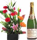 Bottle of Champagne with an Arrangement of Flowers