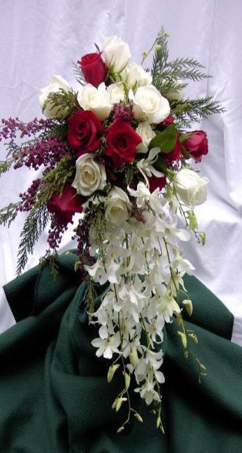 Red and White roses in basket with white orchids