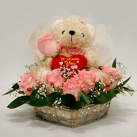 Teddy surrounded with with pink roses basket